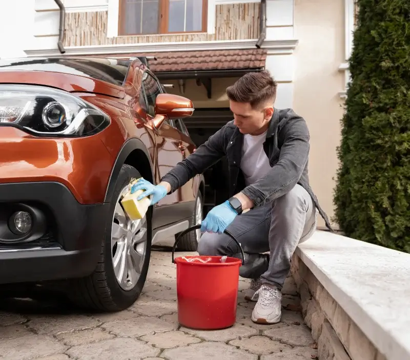 Lavage auto à domicile Villecomtal-sur-Arros : professionnel intervenant sur un véhicule